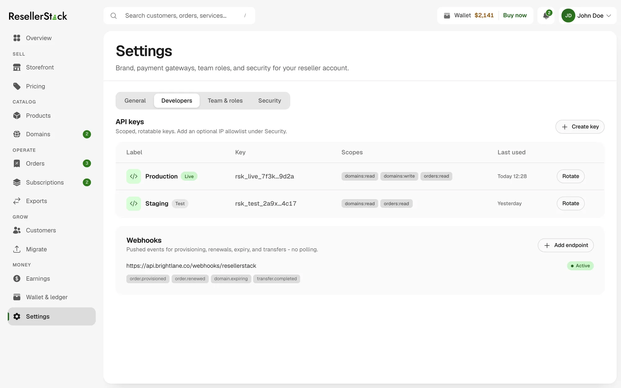 The Developers tab of Settings: scoped, rotatable API keys labelled production and staging with their scopes and last-used times, and a webhook endpoint subscribed to provisioning, renewal, expiry and transfer events